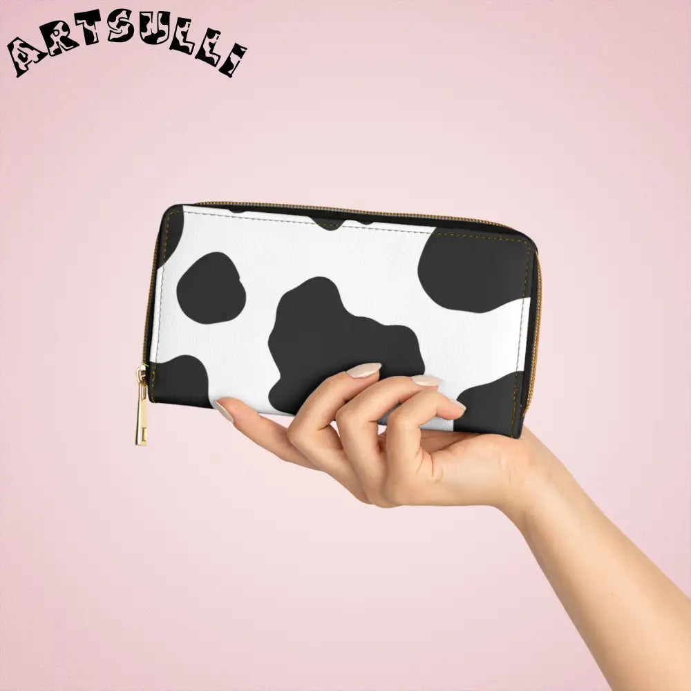 JAKKOUTTHEBXX Cow print zippered wallet displays credit cards with gold hardware 2025