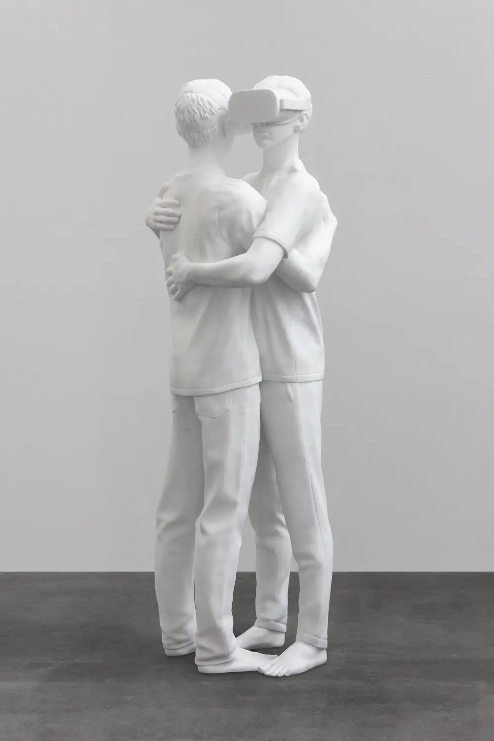 a sculpture by Elmgreen and Dragset of two figures embracing